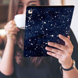 a girl is holding and viewing personalized iPad folio case with Galaxy Universe design 